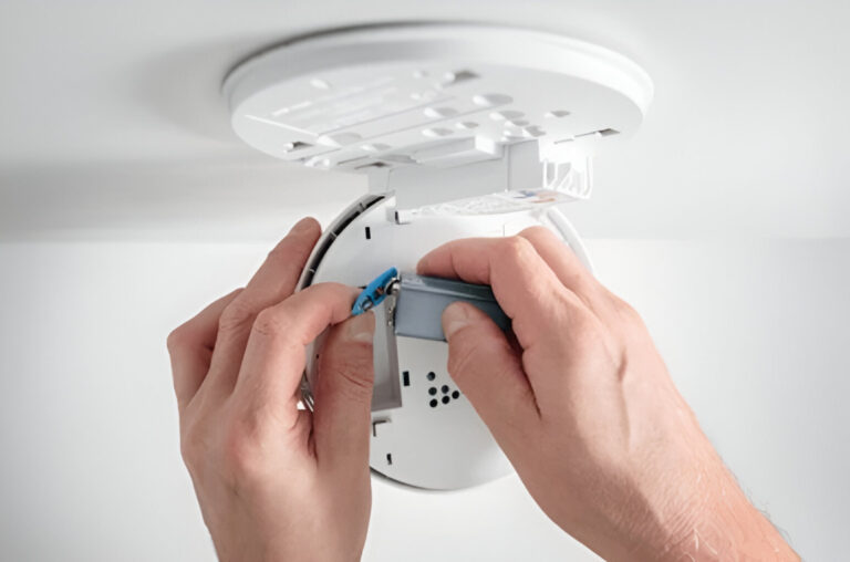 Electrician replacing old or faulty smoke alarms in an Inner West Sydney property