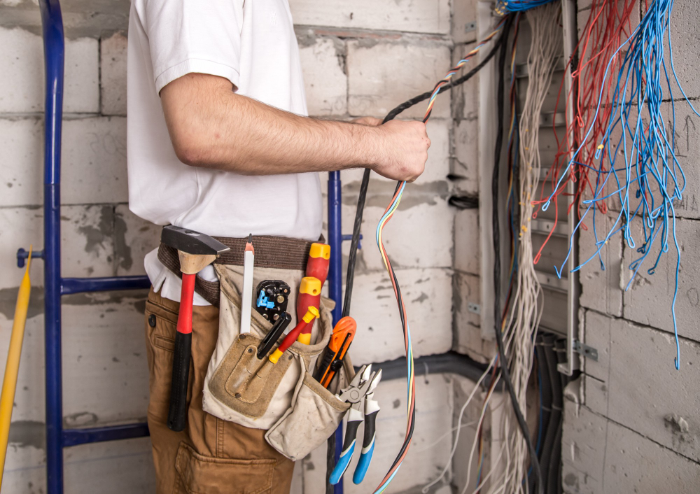Electrician inspecting old wiring during an electrical renovation in a Sydney home